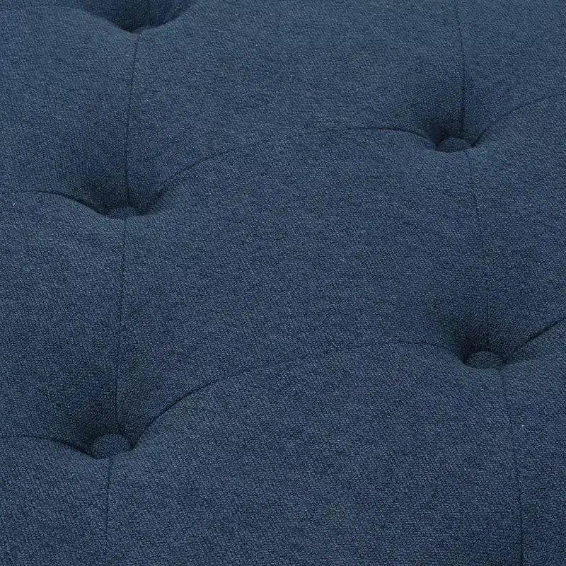 Pouf quadrato capitonné con cuciture a rombi e gambe in betulla